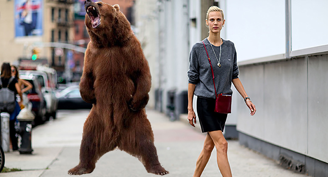 bear stands on hind legs and roars behind unsuspecting blonde woman